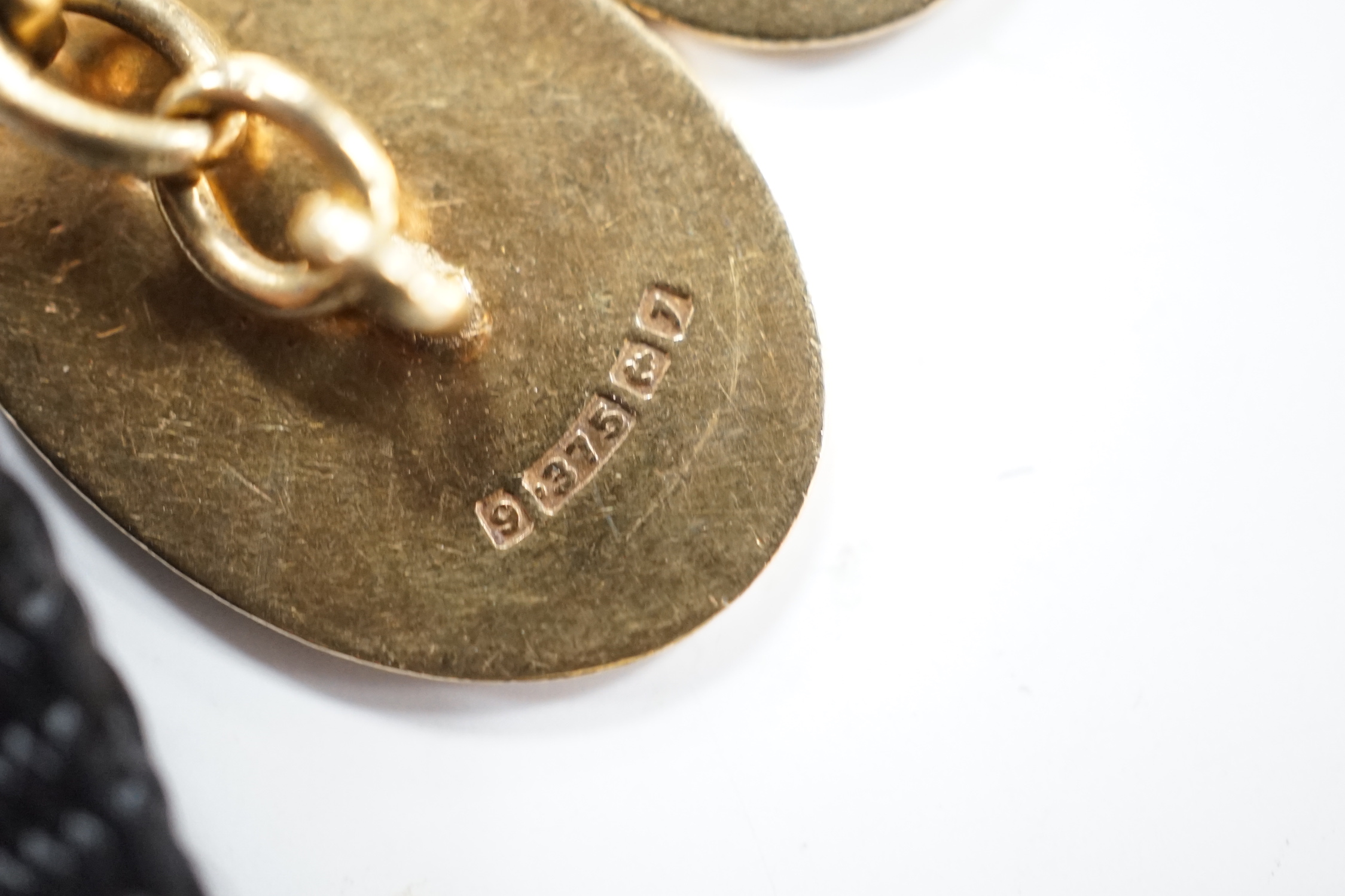 A pair of early 1960's 9ct gold oval cufflinks, with engraved crest and monogram, 10.3 grams.